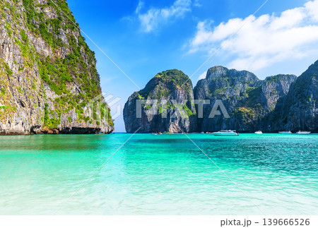 Empty Maya Bay Lagoon with Turquoise Water, Phi Phi islands in Thailand. Clean, minimal tropical seascape of Maya Bay with crystal-clear water and limestone cliffs, ideal for travel advertising and Empty Maya Bay Lagoon with Turquoise Water, Phi Phi islands in Thailand. Clean, minimal tropical seascape of Maya Bay with crystal-clear water and limestone cliffs, ideal for travel advertising and 139666526