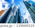 Low angle view of modern glass skyscrapers in financial district. Contemporary corporate architecture symbolizing business, finance and urban development. 139666529