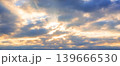Cloudy sky with sun rays breaking through. Atmospheric natural background suitable for weather, spirituality and dramatic visual concepts. 139666530