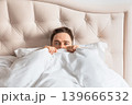 Frightened man lying in bed covering himself with blanket. Concept of fear, anxiety, insomnia and emotional stress. 139666532