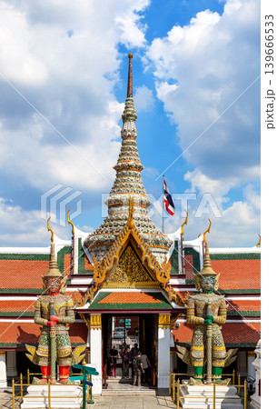 Giant Yaksha guardian statues at the Temple of the Emerald Buddha complex or Wat phra kaew in the Grand Palace grounds in Bangkok, Thailand. Giant Yaksha guardian statues at the Temple of the Emerald Buddha complex or Wat phra kaew in the Grand Palace grounds in Bangkok, Thailand. 139666533