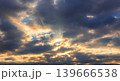 Powerful sky scene with sun rays shining through dramatic clouds. Atmospheric background with contrast light and shadow, perfect for nature, weather and spiritual concepts. 139666538