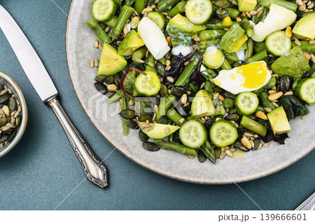 Fresh avocado and asparagus salad with seeds and egg 139666601