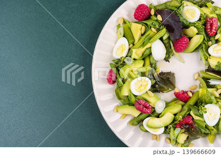 Fresh Green Salad with Asparagus, Avocado, Quail Eggs and Raspberries Fresh Green Salad with Asparagus, Avocado, Quail Eggs and Raspberries 139666609