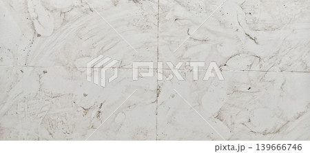 Dirty white ceramic floor with stains and footprints 139666746