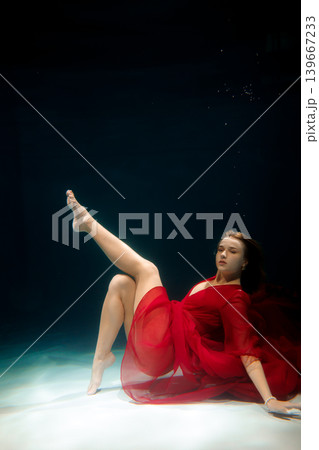 Empowered underwater shot showcasing grace and strength Empowered underwater shot showcasing grace and strength 139667233