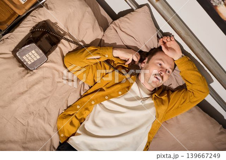 Relaxing musical break. Individual relaxes with guitar and vintage phone Relaxing musical break. Individual relaxes with guitar and vintage phone 139667249