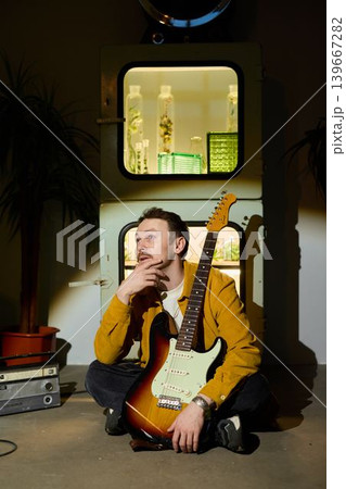 Caucasian songwriter in home studio with electric guitar 139667282
