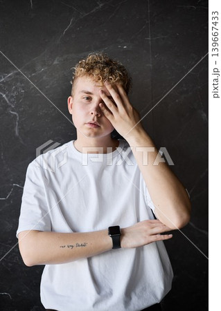 Youthful figure displays fatigue after lengthy day with brief pause 139667433