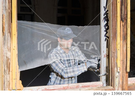 Professional mounting of safety screen on aged wood window frame Professional mounting of safety screen on aged wood window frame 139667565