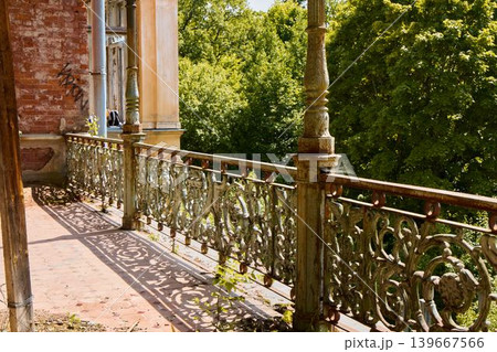 Restoration possibilities of historic balcony overlooking verdant park 139667566
