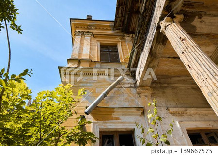 Lush greenery and decayed structures beneath bright blue sky Lush greenery and decayed structures beneath bright blue sky 139667575