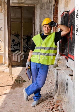 White contractor site supervisor leaning in renovation doorway 139667609