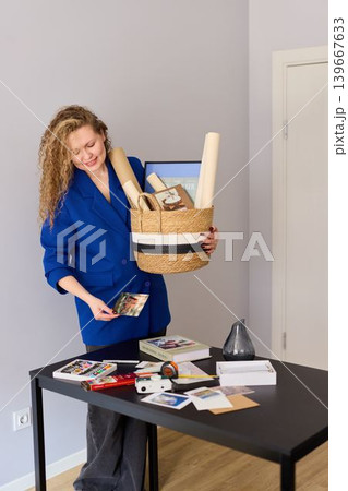 Caucasian woman arranges marketing kits for media outreach Caucasian woman arranges marketing kits for media outreach 139667633