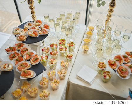 Sophisticated beverage station with savory finger foods and ornate decor Sophisticated beverage station with savory finger foods and ornate decor 139667652