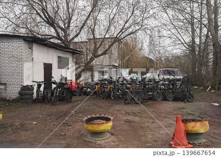 Rugged bike yard. Workshop area filled with bikes and tools Rugged bike yard. Workshop area filled with bikes and tools 139667654