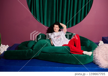Caucasian woman laughing on plush sofa creative producer moment Caucasian woman laughing on plush sofa creative producer moment 139667705