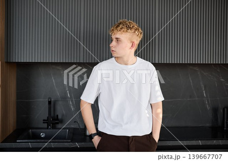 Young man stands by marble surface calmly during morning preparations 139667707