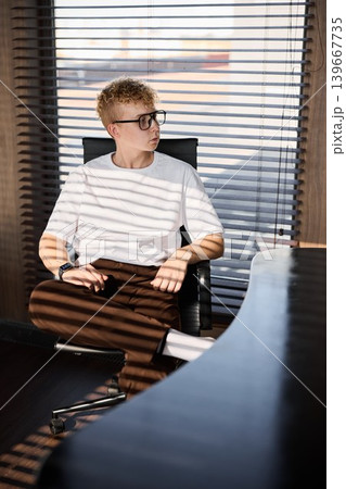 Young caucasian male leaning back, reflective consultant planning 139667735