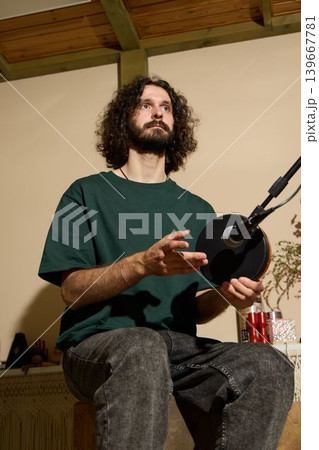 Expressive performer improvises intricate handpan melodies 139667781