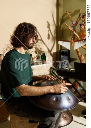 Warmly styled setting with musician deeply reflecting on sounds Warmly styled setting with musician deeply reflecting on sounds 139667783