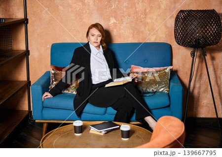 Confident female professional resting in stylish lounge 139667795