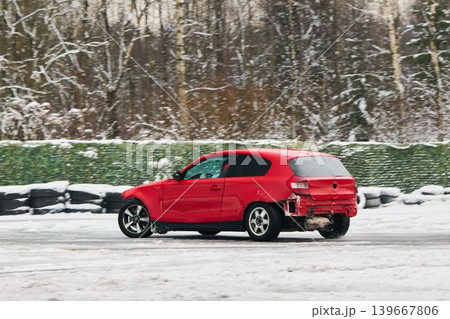 Automobile shows damage while negotiating snowcovered sharp turn 139667806