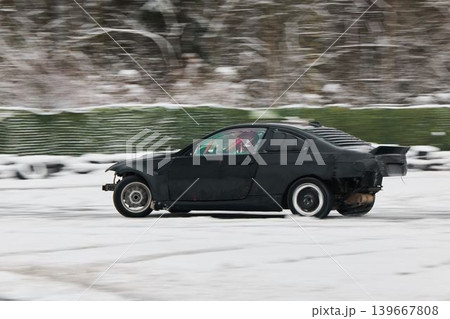 Dynamic black coupe navigating snowy terrain with style Dynamic black coupe navigating snowy terrain with style 139667808