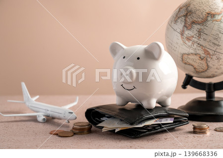 Piggy bank on wallet with globe, savings personal finance international budgeting and travel finance concept 139668336
