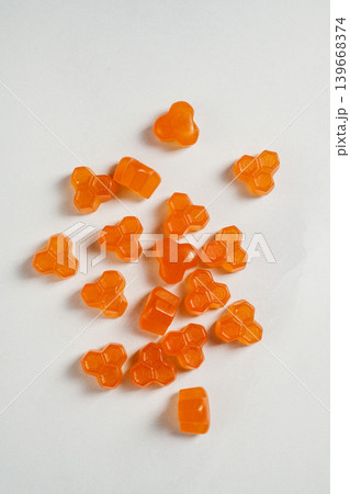 Jelly gummies fruit vitamins on bright background, food supplements.Orange vitamins candies Jelly gummies fruit vitamins on bright background, food supplements.Orange vitamins candies 139668374
