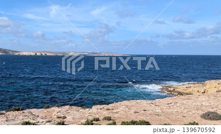 View of the Mediterranean Sea with sailing yachts far behind in a windy day at the coast View of the Mediterranean Sea with sailing yachts far behind in a windy day at the coast 139670592