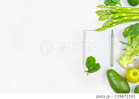 Healthy food border with vegetables notebook and copy space on white background top view 139671591