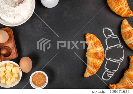 Fresh croissants with baking ingredients and chalk sketch on black background, top view bakery banner Fresh croissants with baking ingredients and chalk sketch on black background, top view bakery banner 139671622