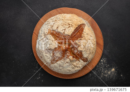 Artisan sourdough bread loaf on dark rustic background top view with copy space for bakery branding 139671675