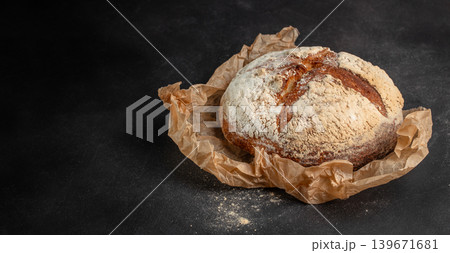 Rustic artisan sourdough bread on dark background with copy space for bakery advertising 139671681