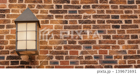 Vintage outdoor lantern on rustic brick wall with warm sunlight Vintage outdoor lantern on rustic brick wall with warm sunlight 139671691