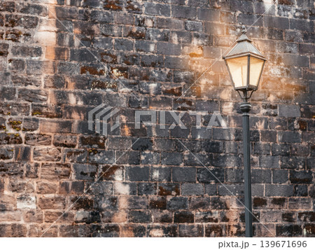 Vintage street lamp near old brick wall background with copy space Vintage street lamp near old brick wall background with copy space 139671696