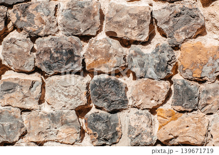 Stone wall texture background with rustic rock masonry pattern Stone wall texture background with rustic rock masonry pattern 139671719