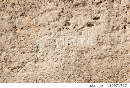 Light limestone wall texture with porous rough surface background Light limestone wall texture with porous rough surface background 139671727