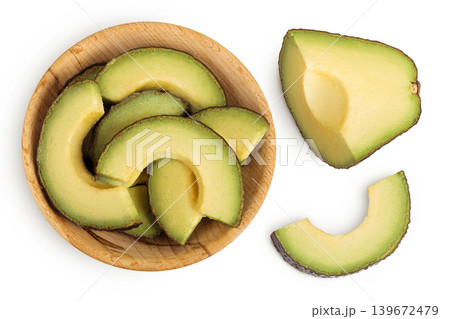 avocado slices in wooden bowl isolated on white background close up. Top view. Flat lay avocado slices in wooden bowl isolated on white background close up. Top view. Flat lay 139672479