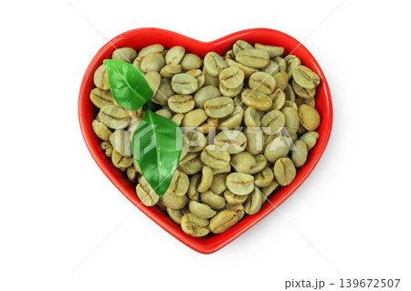 Green coffee beans in ceramic bowl isolated on white background. Top view Green coffee beans in ceramic bowl isolated on white background. Top view 139672507