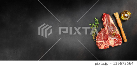 Raw porterhouse t-bone steak with herbs and oil on dark background with copy space for premium steakhouse advertising Raw porterhouse t-bone steak with herbs and oil on dark background with copy space for premium steakhouse advertising 139672564