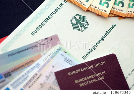German passport and an identity card on an official naturalization certificate 139673340