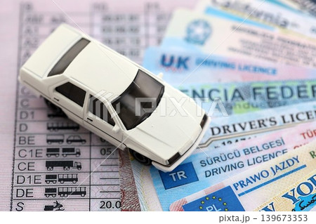 Toy car on driving licenses from different countries and American states 139673353