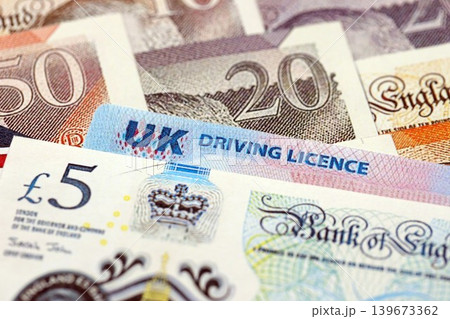 United Kingdom driving license card on UK British pounds money 139673362