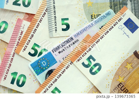 German driving license card called Fuhrerschein lies on big amount of european Euro money bills 139673365