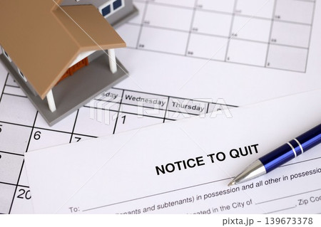 Generic toy house and eviction notice or notice to quit on table Generic toy house and eviction notice or notice to quit on table 139673378