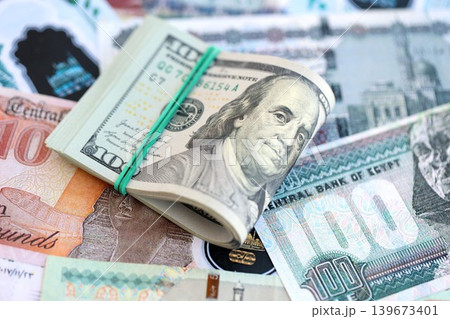 Egyptian pound currency money bills and bunch of us dollars. The concept of currency exchange 139673401