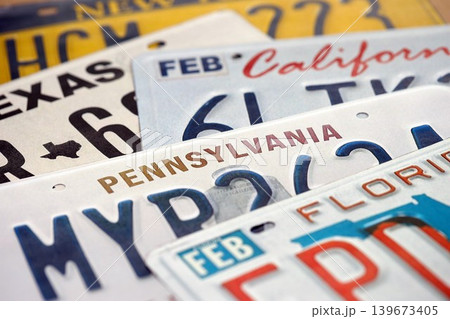 Old US car license plates with various state names close up. Concept of driving in United States Old US car license plates with various state names close up. Concept of driving in United States 139673405