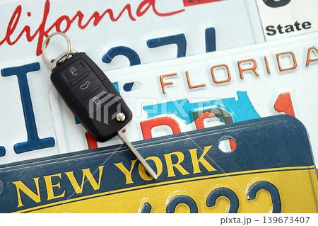 Remote control car keys on US license plates with state names. Driving in United States 139673407
